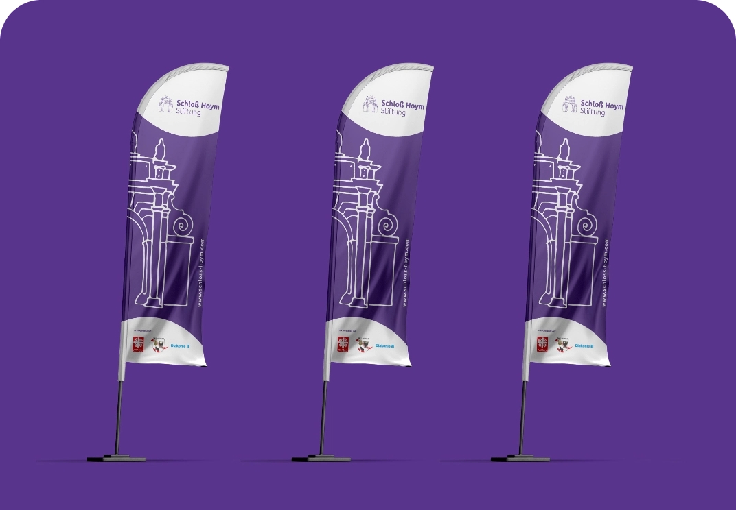 Drei violette Hissfahnen der Schloß Hoym Stiftung mit weißem Motiv eines Tores und der Internetadresse